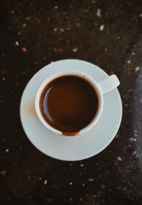 Free Captivating overhead shot of a rich, warm espresso in a white cup. Stock Photo
