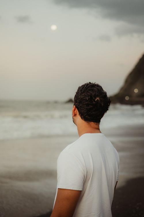 Contemplative Man Watching Sunset by the Sea · Free Stock Photo
