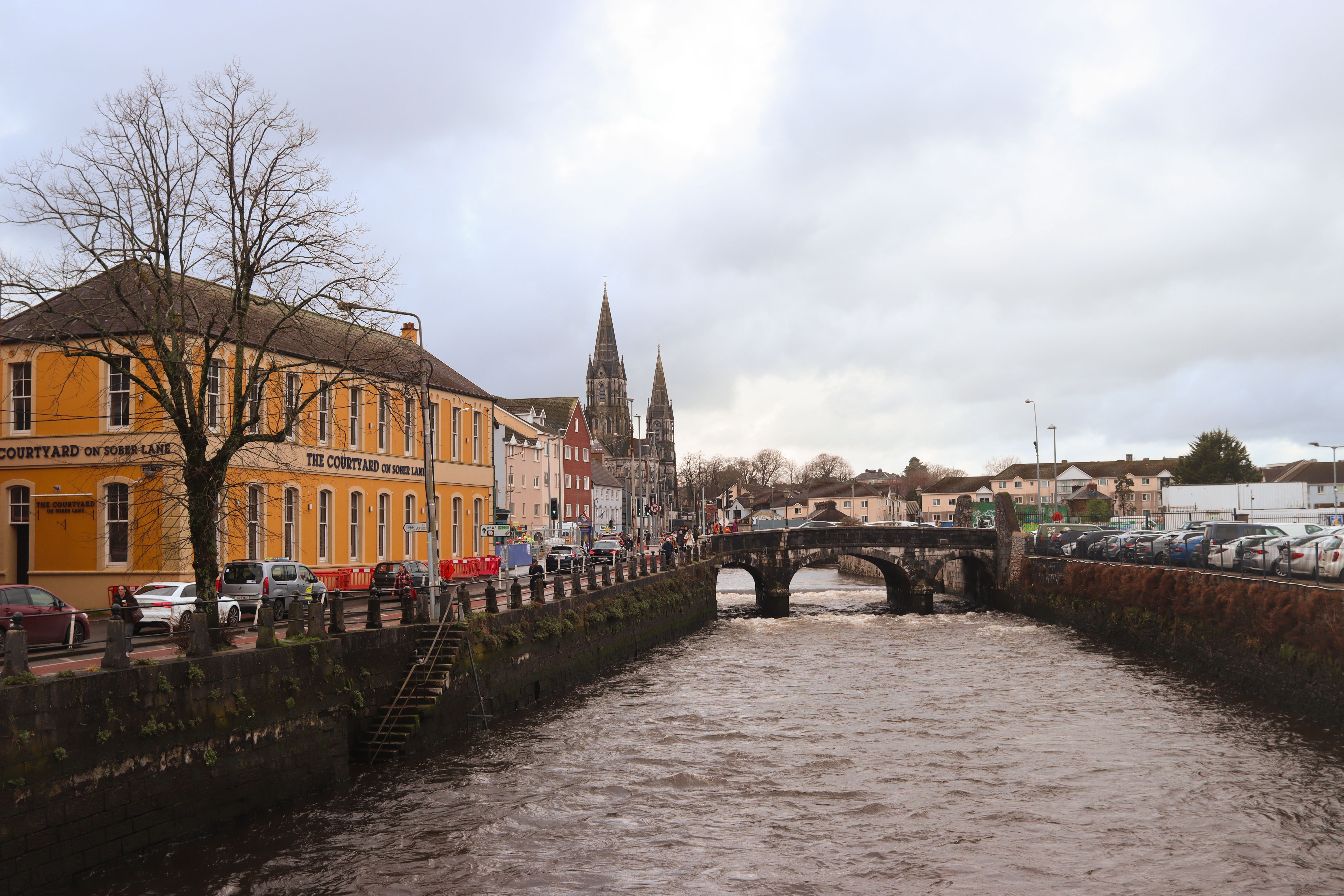 Bridge over a river beside historic buildings on an overcast winter day in Cork, Republic of Ireland.