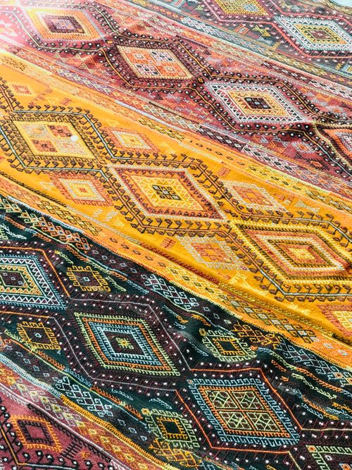 Free Close-up of vibrant geometric patterned textile with diverse colors for design inspiration. Stock Photo