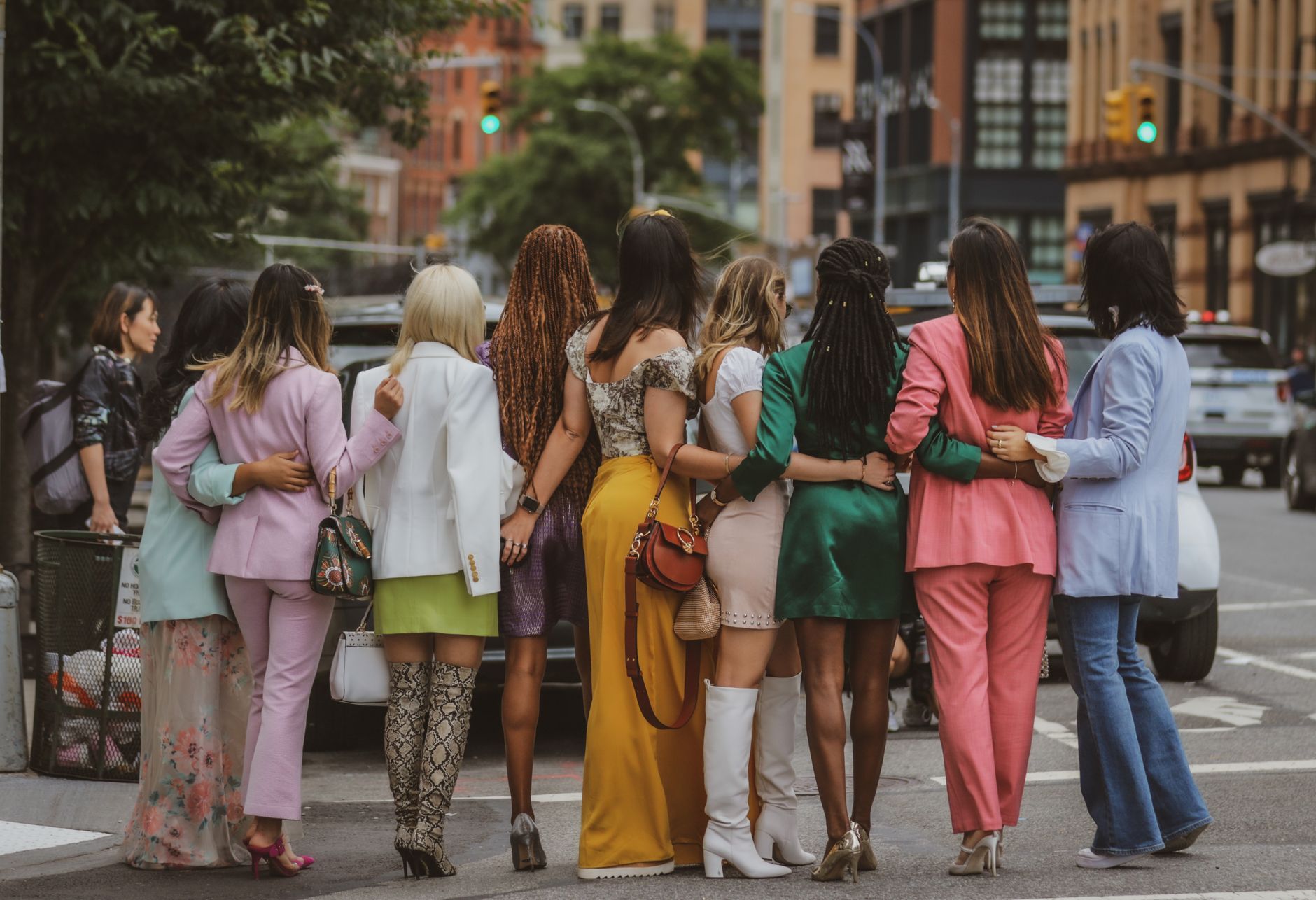 Stylish women in colorful outfits walking together in New York City street.
