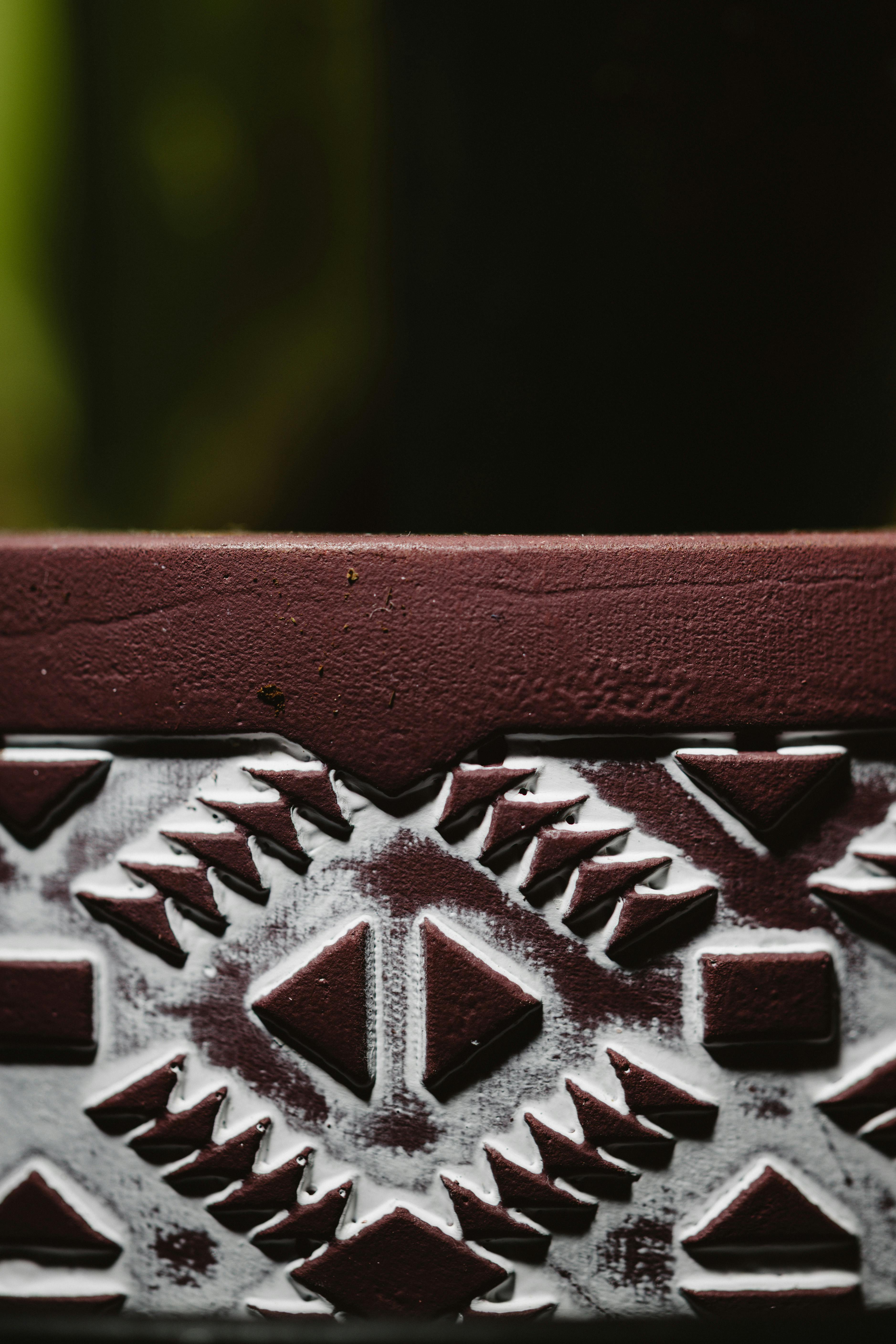 Free Detailed view of a red and white geometric pattern on a pottery surface, with rich texture. Stock Photo