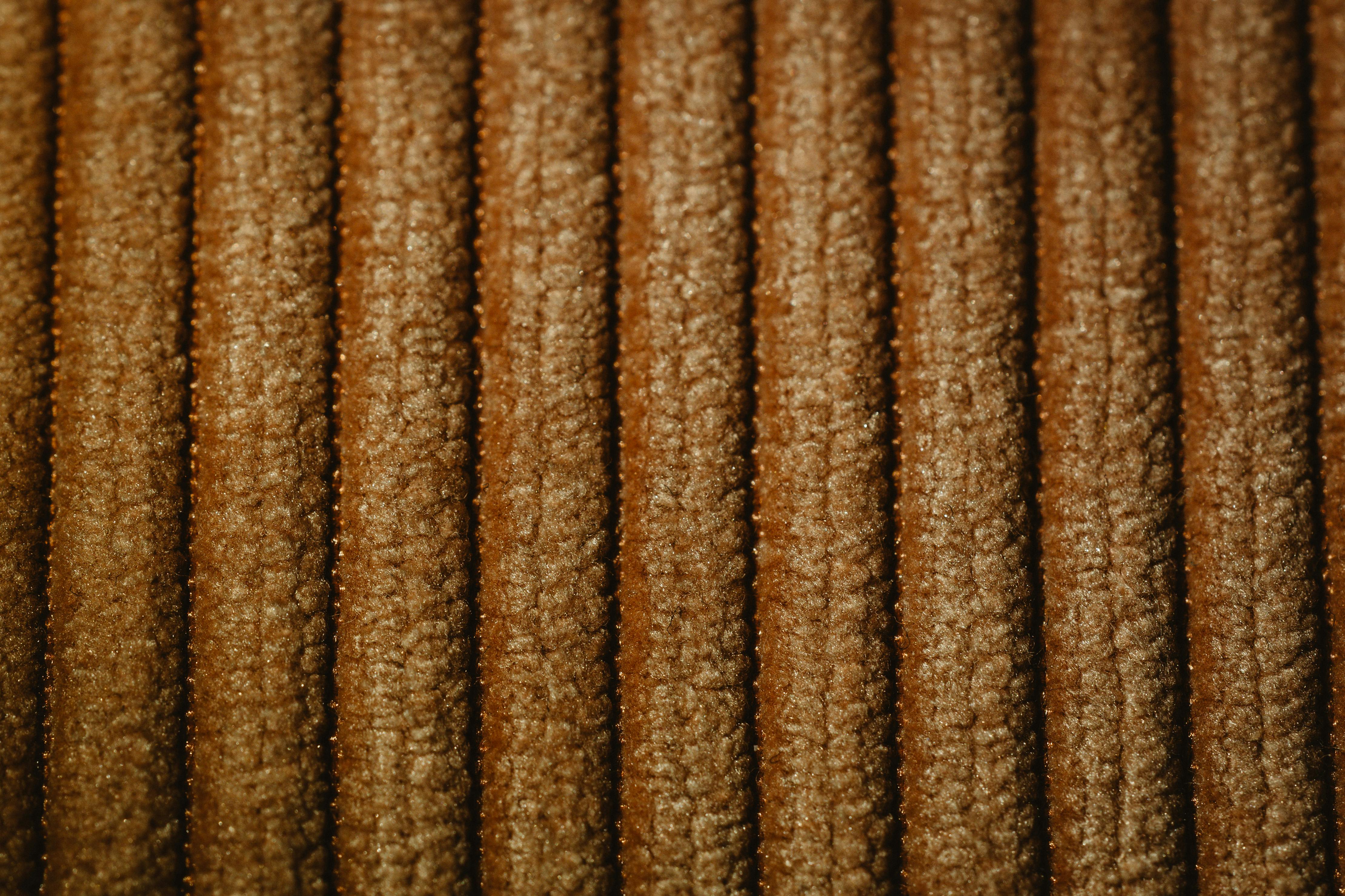 Free Detailed close-up view of textured brown fabric with a unique pattern and shadow play. Stock Photo