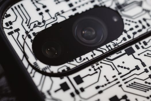 Macro shot of an electronic circuit design around a smartphone camera lens, showing intricate details.