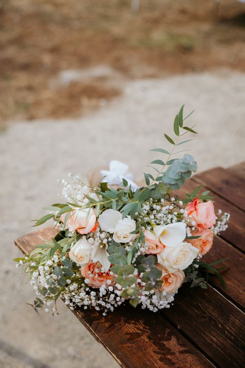 Free Beautiful bridal bouquet with roses and eucalyptus on a wooden table outdoors. Stock Photo