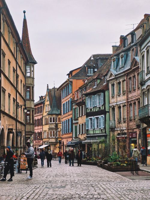 Free Scenic view of a charming street in Colmar, France during fall with half-timbered buildings. Stock Photo