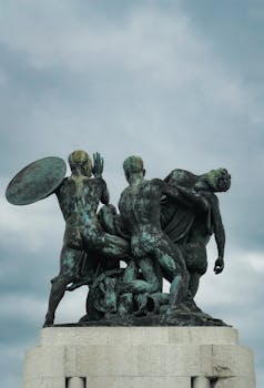 A striking bronze sculpture stands tall in Trieste, set against a dramatic cloudy sky.