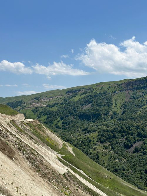 Free Explore a vibrant mountain landscape with lush greenery and clear skies in summer. Stock Photo