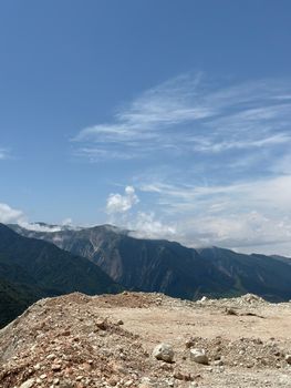 A breathtaking view of vast mountains under a bright summer sky, perfect for nature enthusiasts.