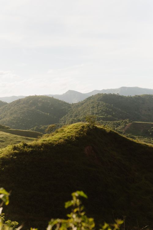 Free A tranquil mountain landscape with lush, green hills under a clear sky. Stock Photo