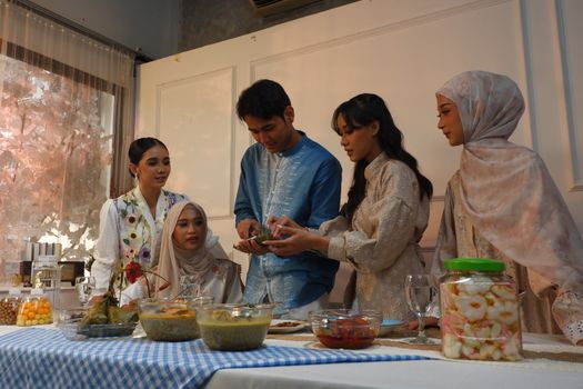Friends enjoying a traditional meal together indoors. Bright and warm atmosphere.