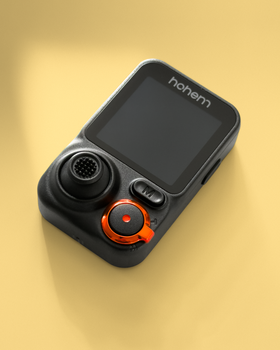 Sleek black action camera with orange details on a yellow background, ideal for tech enthusiasts.