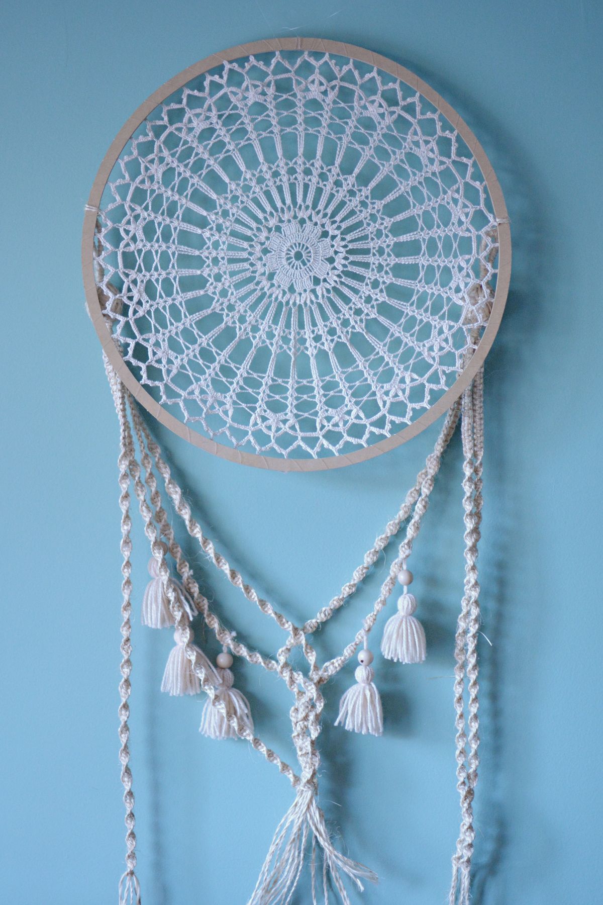 White macrame dreamcatcher with tassels and beads