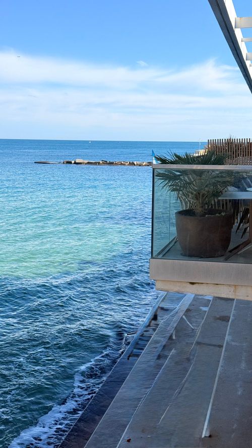Free Stylish glass balcony overlooking the azure Mediterranean waters in Barcelona, Spain. Stock Photo