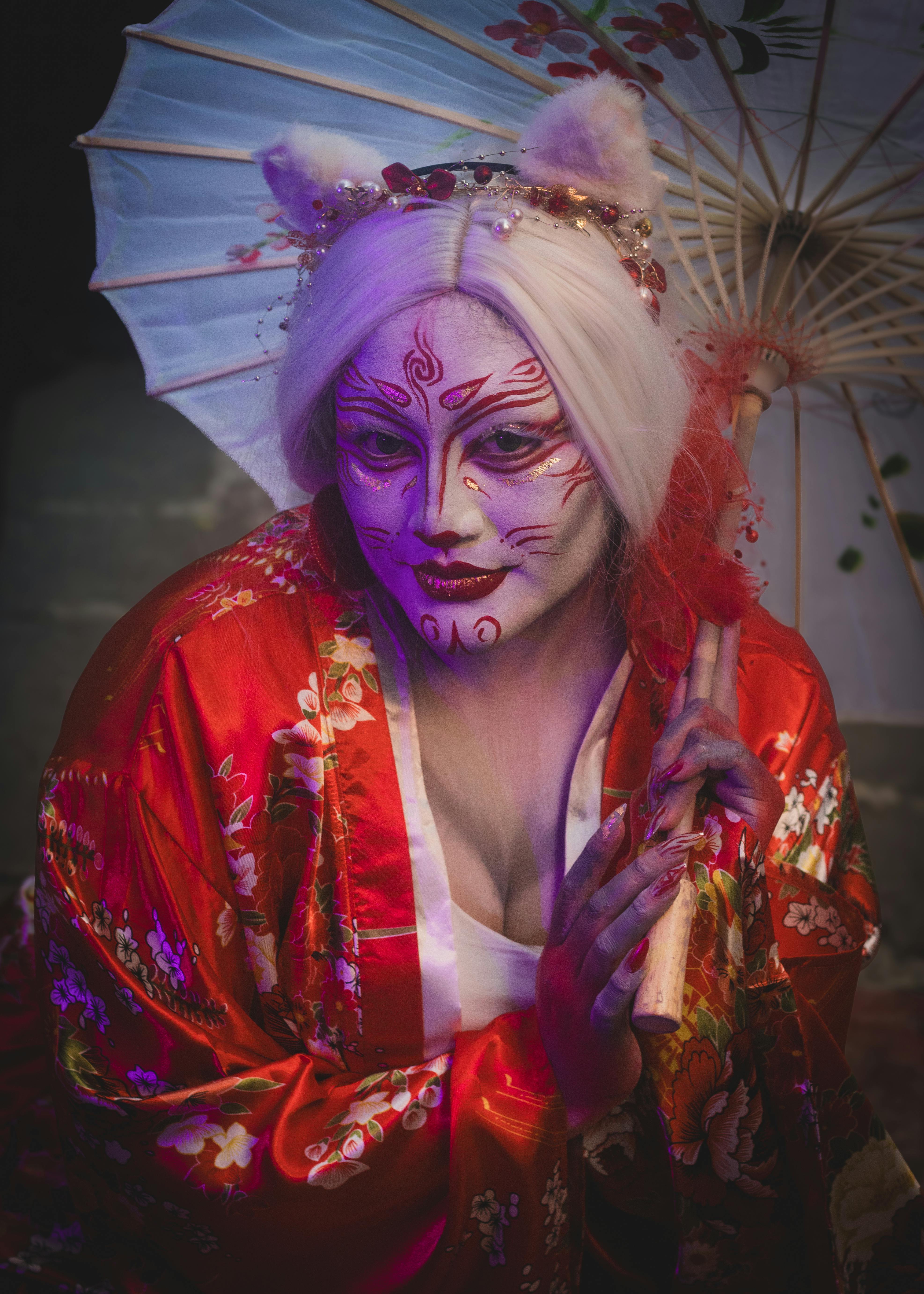 Gratuit Portret mistic al unei persoane în costum de inspirație asiatică, care ține o umbrelă de soare ornamentată. Fotografie de stoc