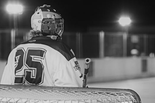 A roller hockey player in Tucson, Arizona, during a nighttime game captured in black and white.