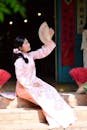 Traditional Asian Woman in Pink Dress with Fan