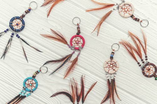 Free Dreamcatcher Charms on Wooden Surface Stock Photo