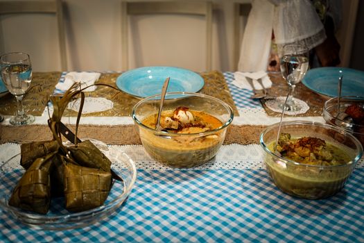 A beautifully arranged Indonesian festive meal showcasing traditional dishes on a dining table.