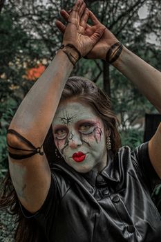 Female model with artistic makeup resembling a doll in a green park in Mexico City.