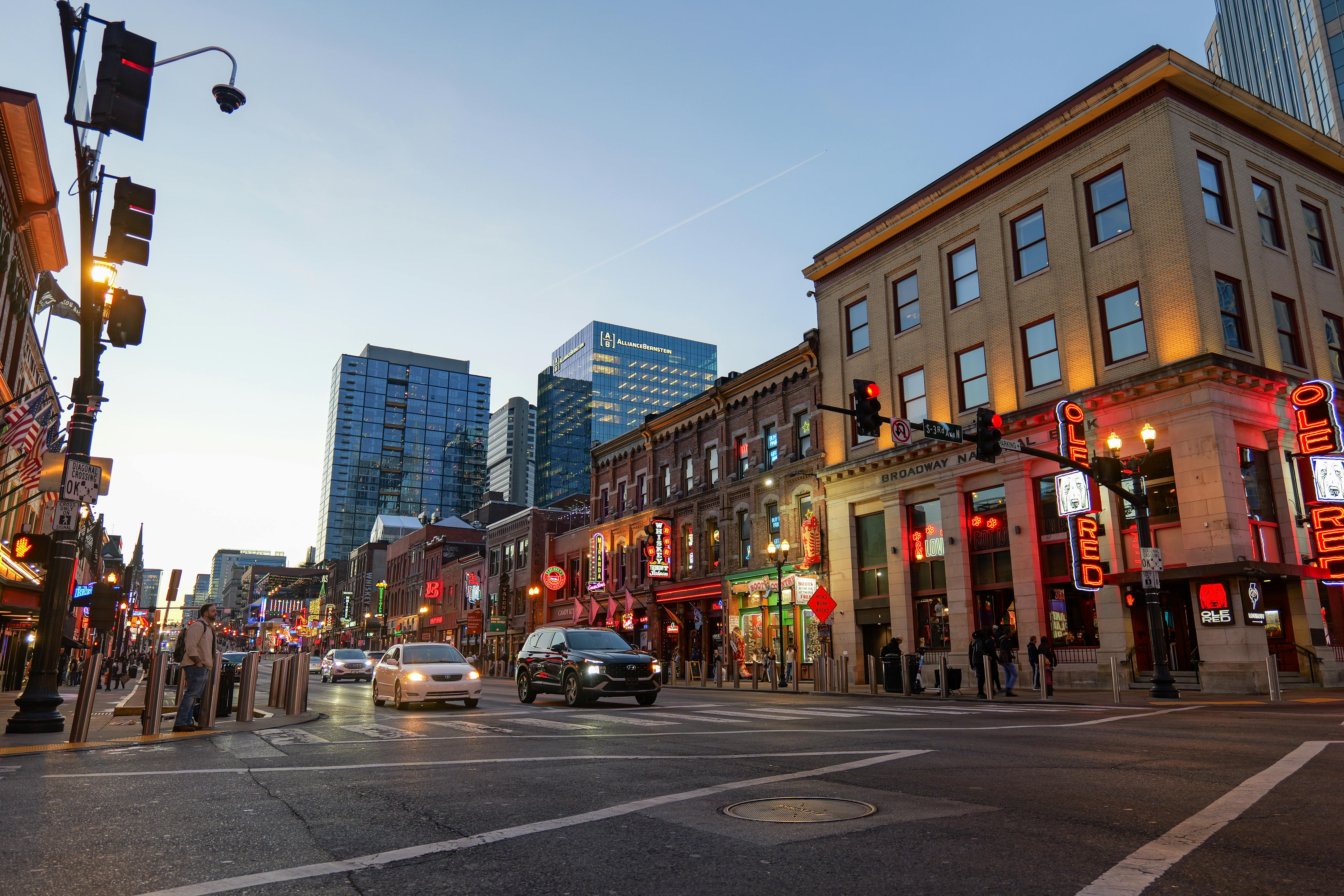 Nashville cityscape at dusk with lights reflecting on the river