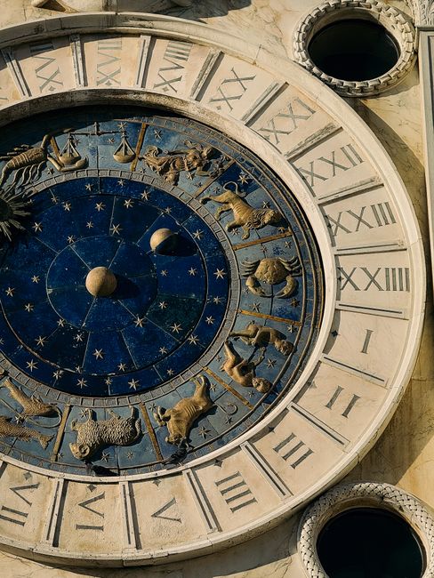 A close-up of the Zodiac signs on the iconic St Mark's Clocktower in Venice, Italy.