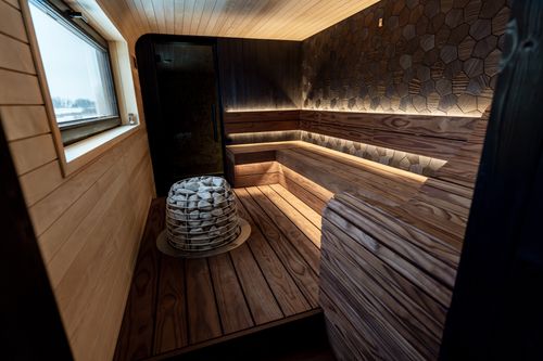 Free A beautifully designed indoor sauna featuring wood panels and LED lighting, showcasing Nordic aesthetics. Stock Photo