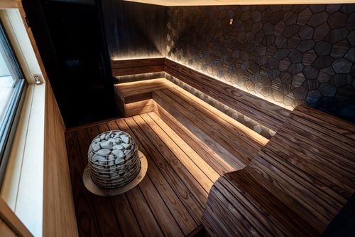 Free Elegant Nordic design sauna featuring LED lighting and wooden interiors for a relaxing ambiance. Stock Photo