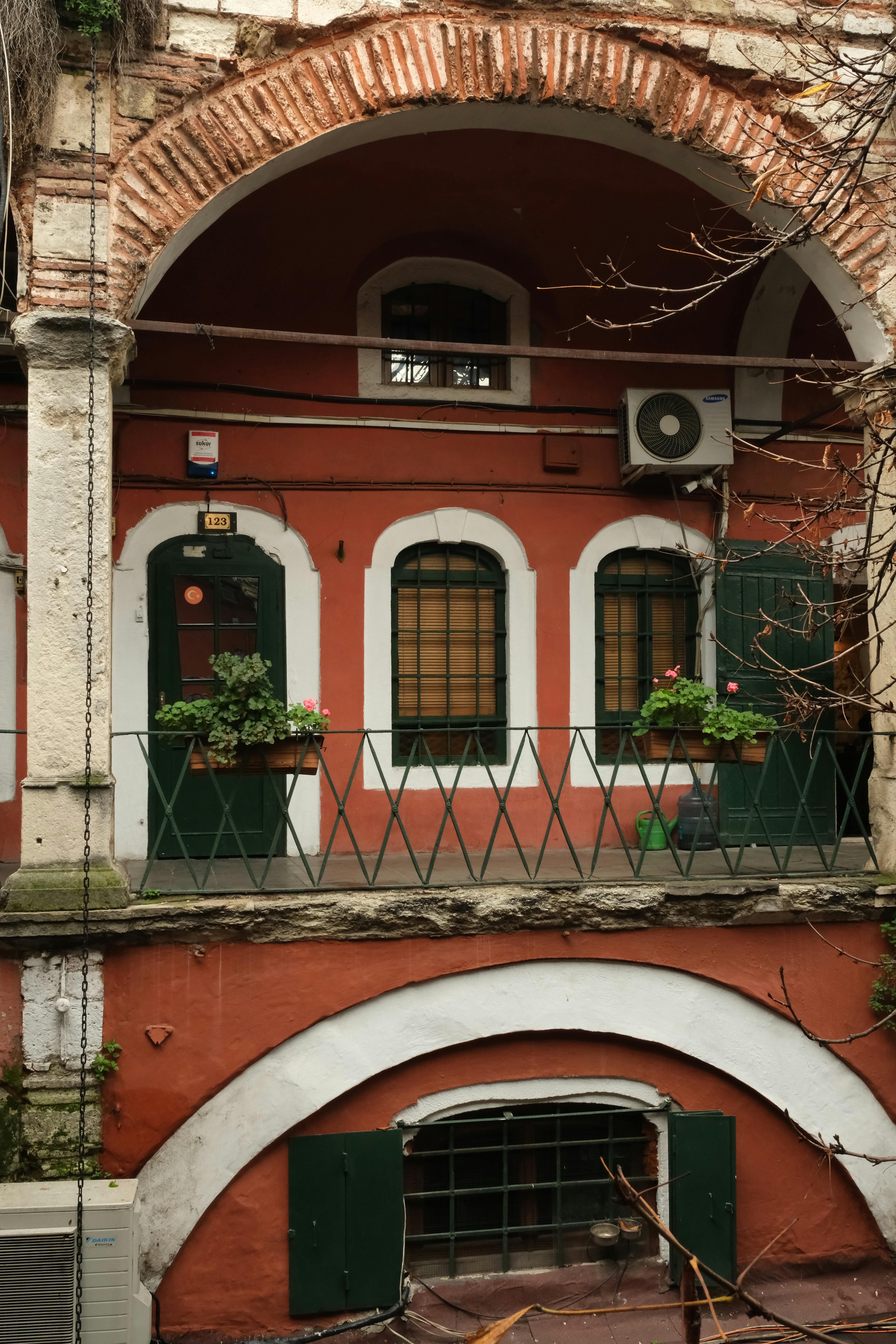 Free Charming historic Istanbul building with arched windows and red facade. Stock Photo