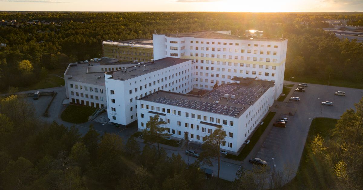 Aerial view of a modern hospital campus surrounded by greenery
