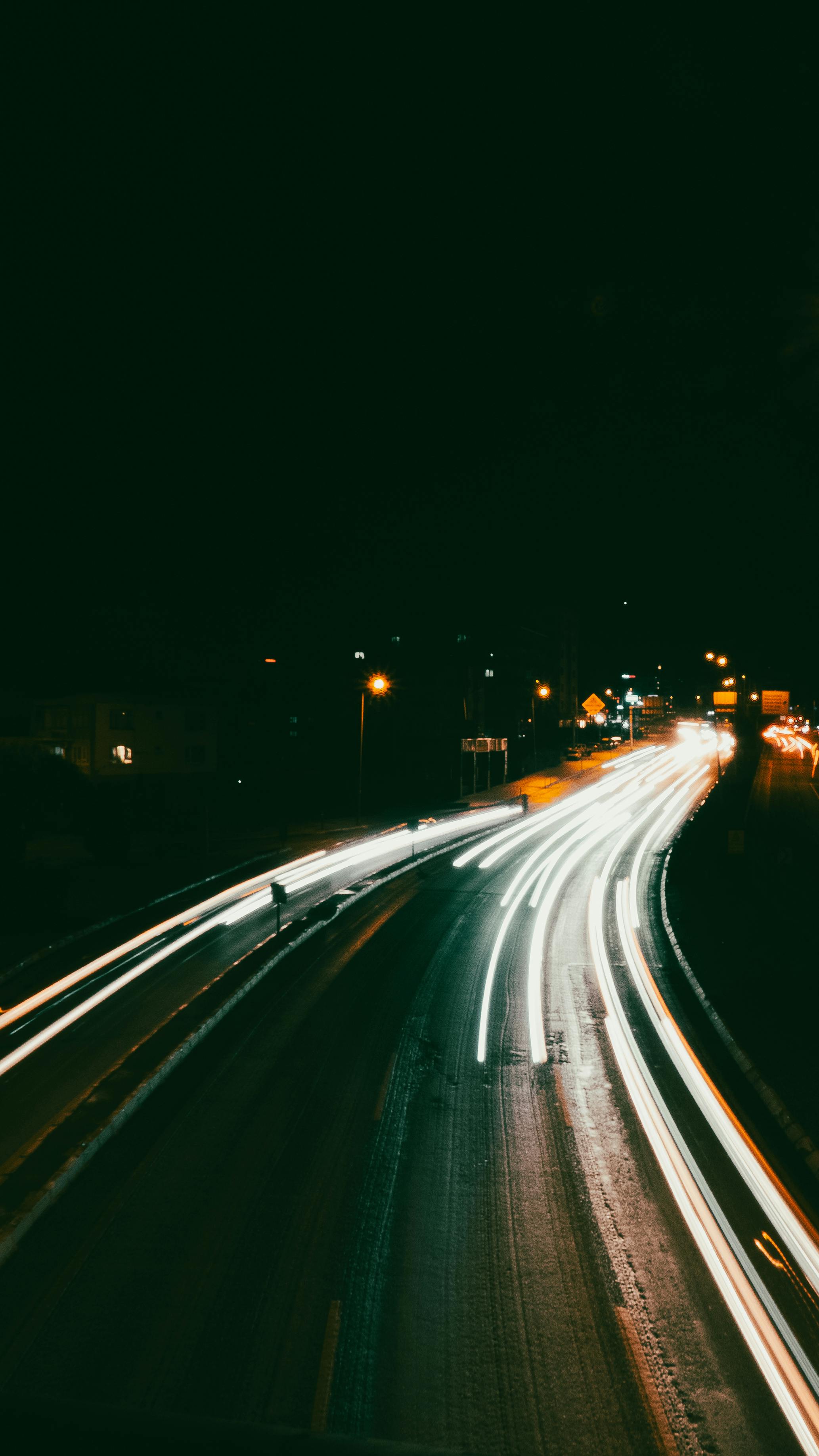 gratis Fascinerende lange belichting van autolichten die 's nachts lichtsporen achterlaten op een snelweg. Stockfoto