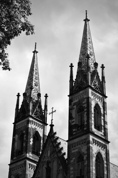 Free Black and white photo of gothic church spires with intricate details against a cloudy sky. Stock Photo