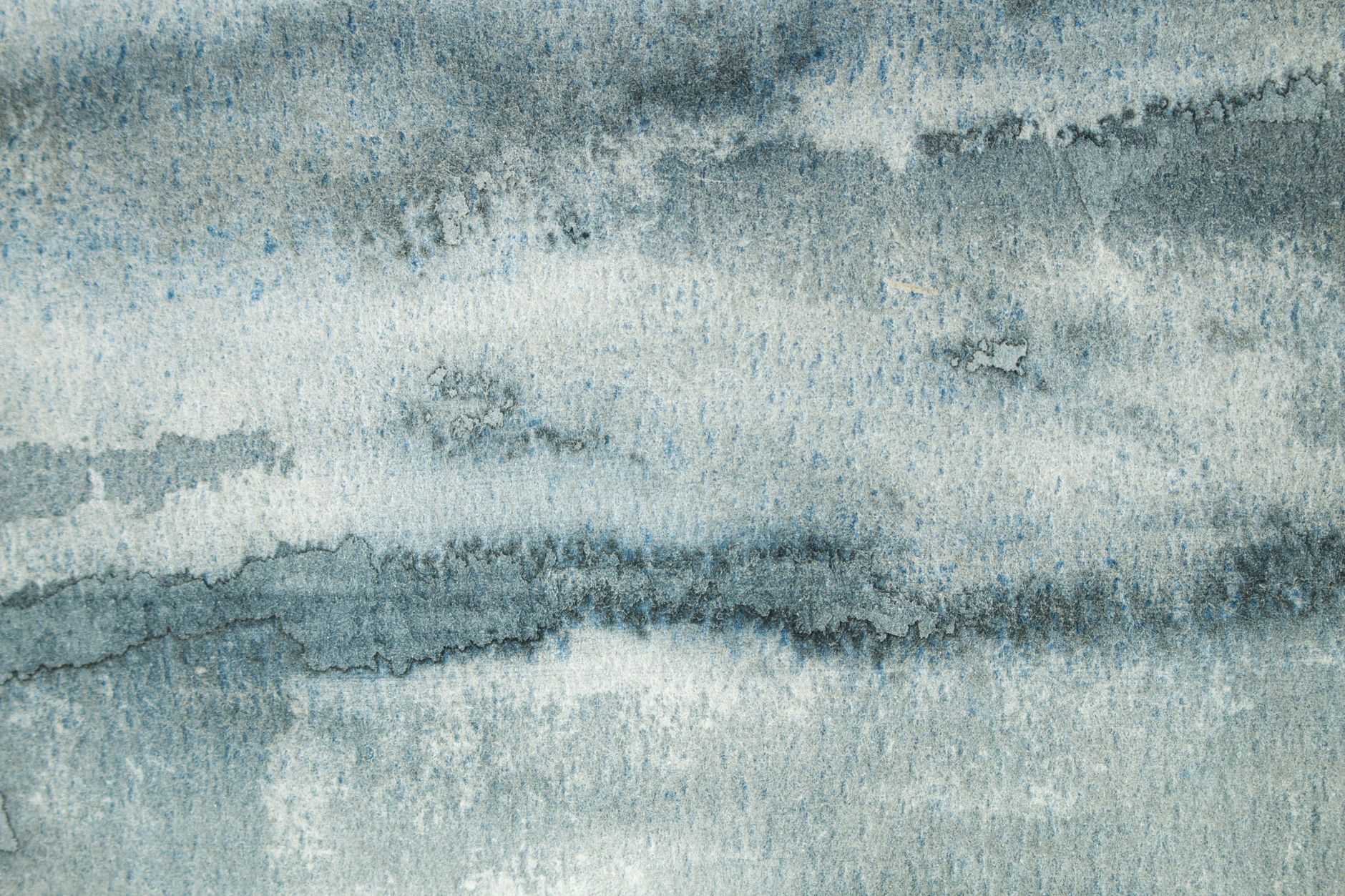 Abstract blue watercolor texture creating a calm and serene atmosphere.