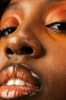 Artistic studio close-up portrait of a woman with elegant makeup and style.