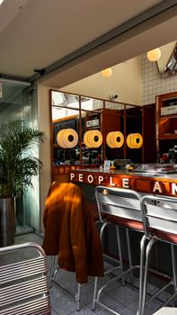Cozy modern cafe interior with retro lighting and decor, creating a warm, inviting space.
