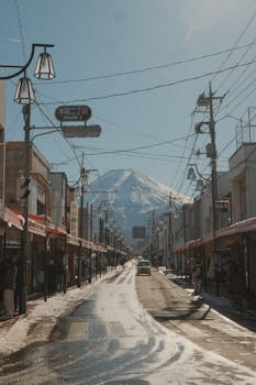 Quaint Japanese street with Mount Fuji in the background during winter.