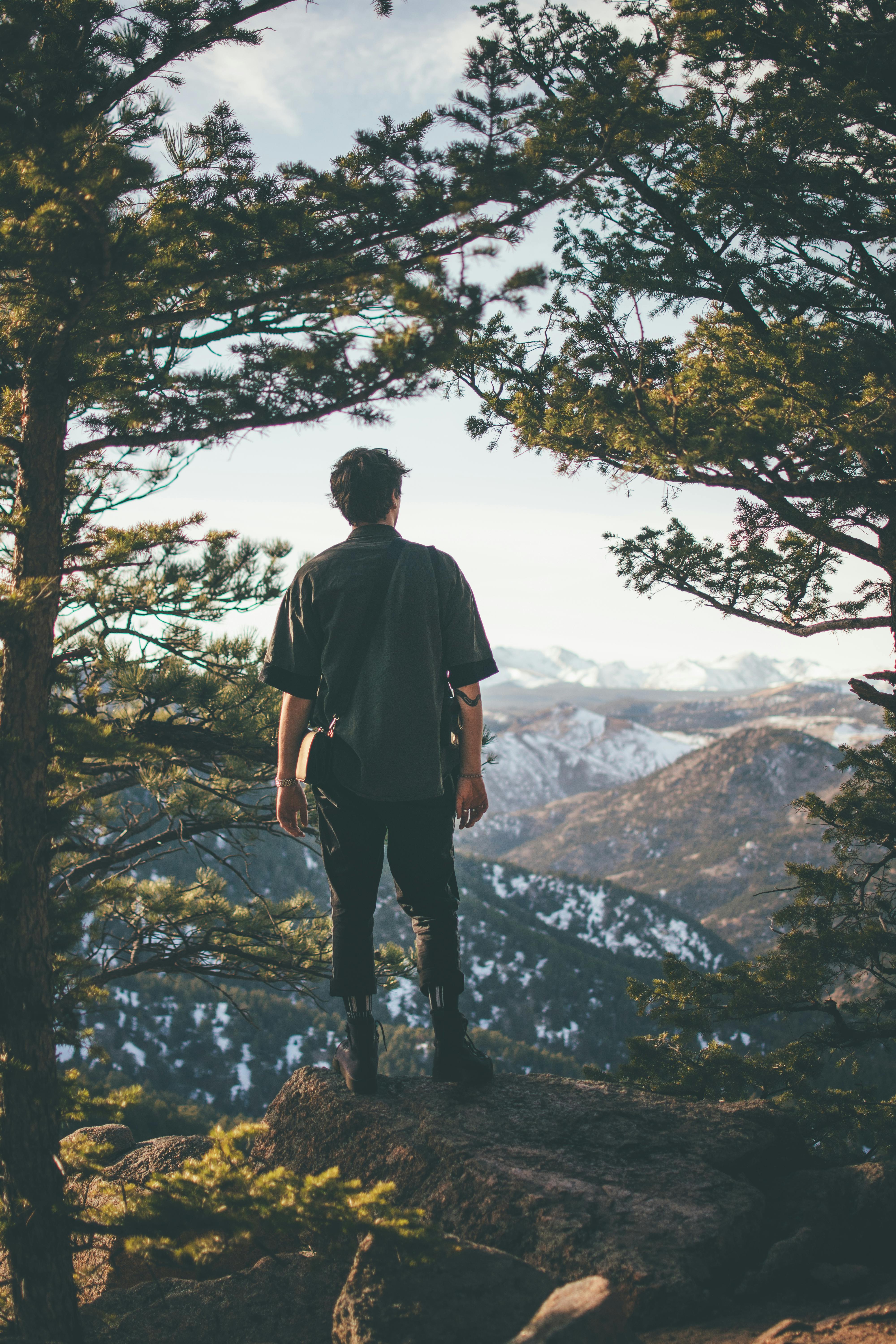 man standing on cliff edge