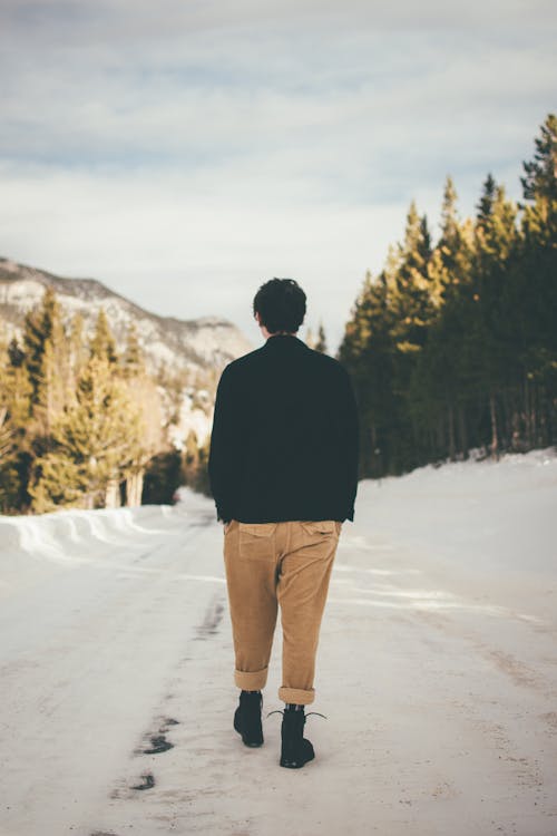 Free Photo of Person Walking on Snow Covered Ground Stock Photo