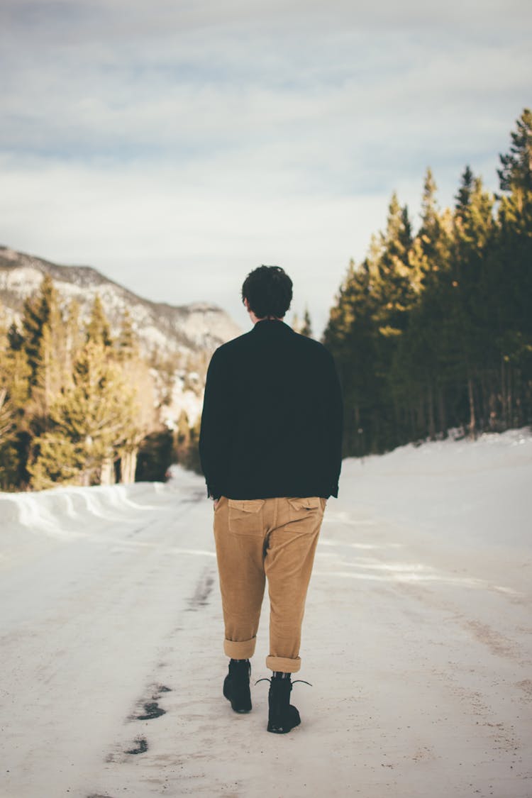 Photo Of Person Walking On Snow Covered Ground