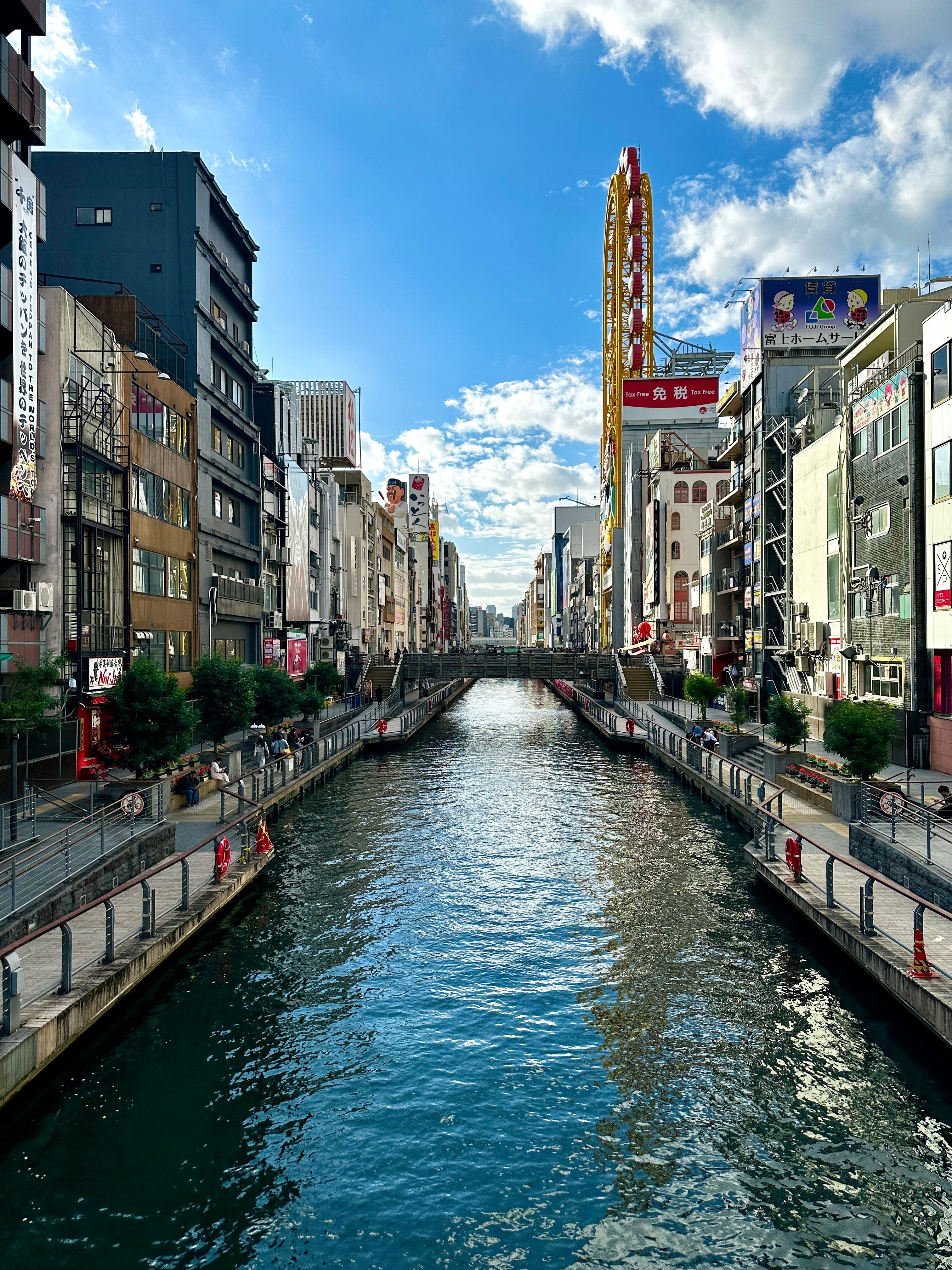 Dotonbori canal lined with signs and riverside buildings in Osaka.