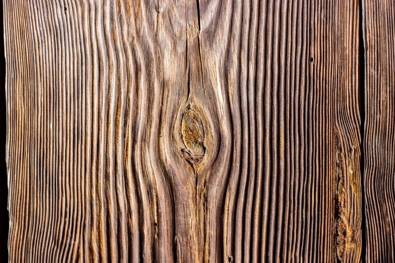 Detailed view of wooden texture showing natural grain patterns and rich brown hues.
