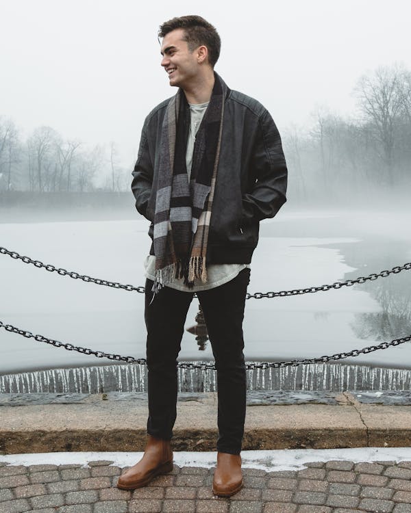 Man with Black and Gray Scarf Smiling