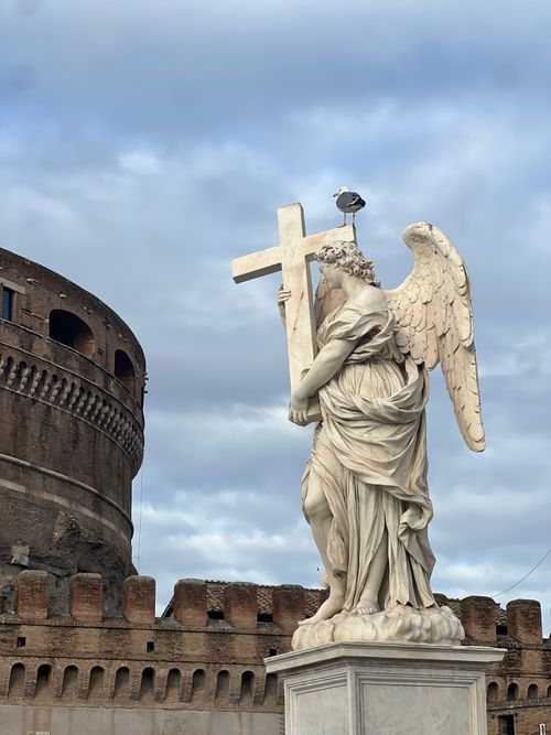 Free Majestic angel statue holding a cross outside Castel Sant'Angelo in Rome. Stock Photo