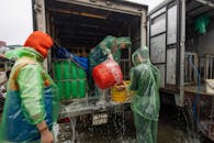 Workers unloading in rainy Hà Nội market