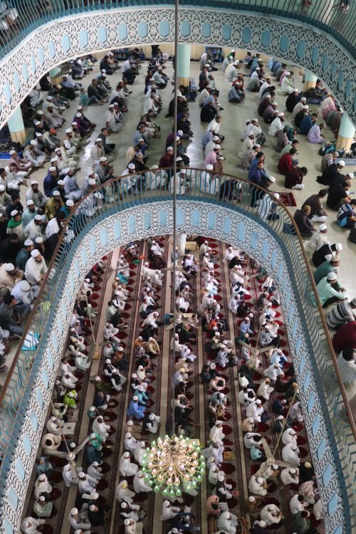 Free Aerial view of a congregation gathered for prayer in a beautifully decorated mosque. Stock Photo