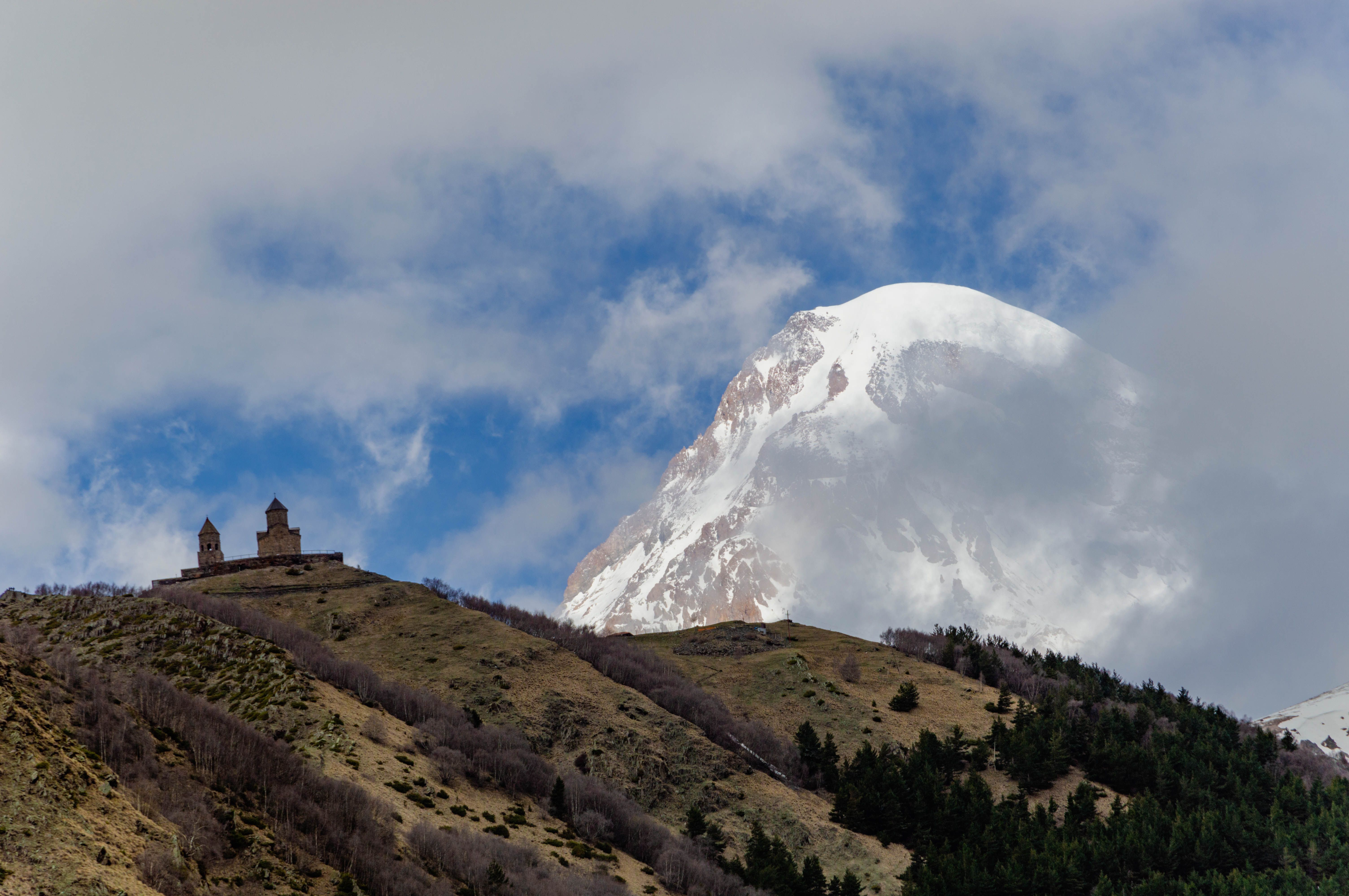 A marshrutka (minibus) traveling through the scenic mountains near Stepantsminda, Georgia