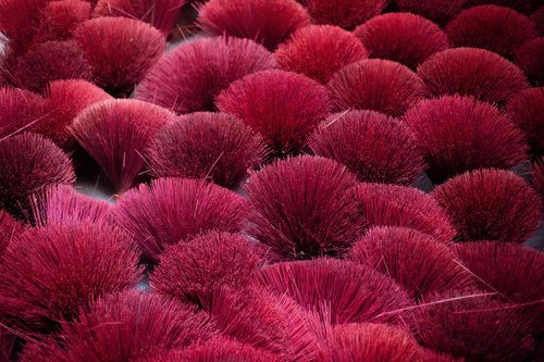 Free A striking arrangement of red incense sticks creating a vivid and dynamic pattern. Stock Photo