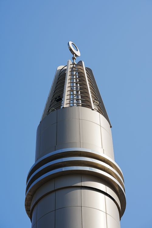 Free Close-up of a modern minaret in Dubai, UAE, under a clear blue sky, showcasing sleek architecture. Stock Photo