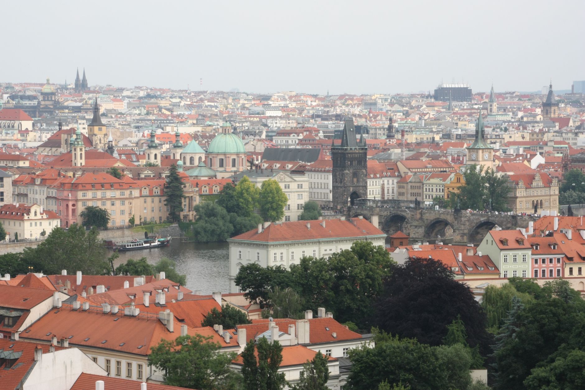Aerial view of Prague featuring Charles Bridge and historic Old Town.