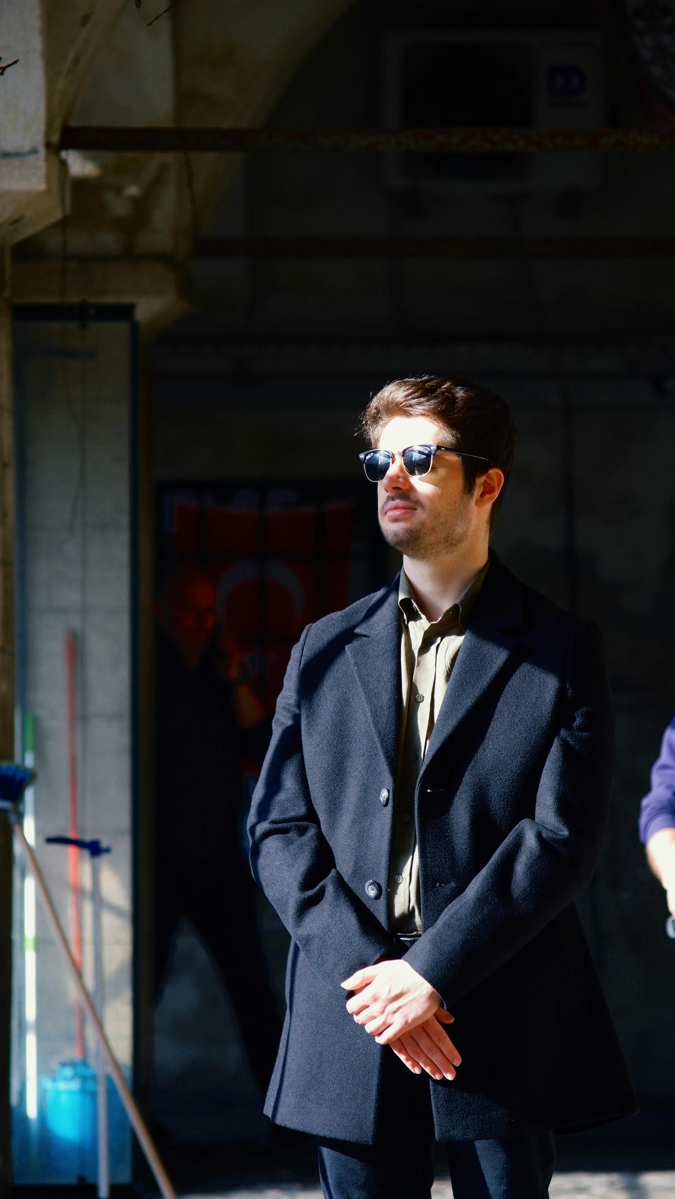 Portrait of a fashionable man in sunglasses, standing confidently in an urban location, İstanbul.